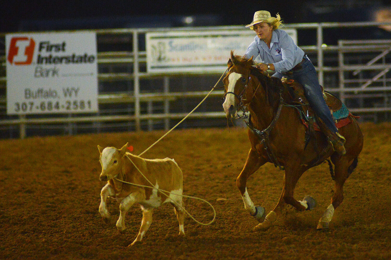 Devin Dixon wraps her rope around the head of her calf